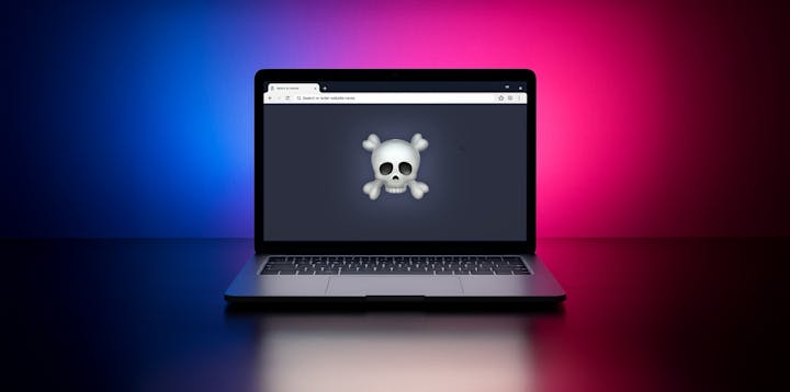 A laptop with a skull emoji on the screen