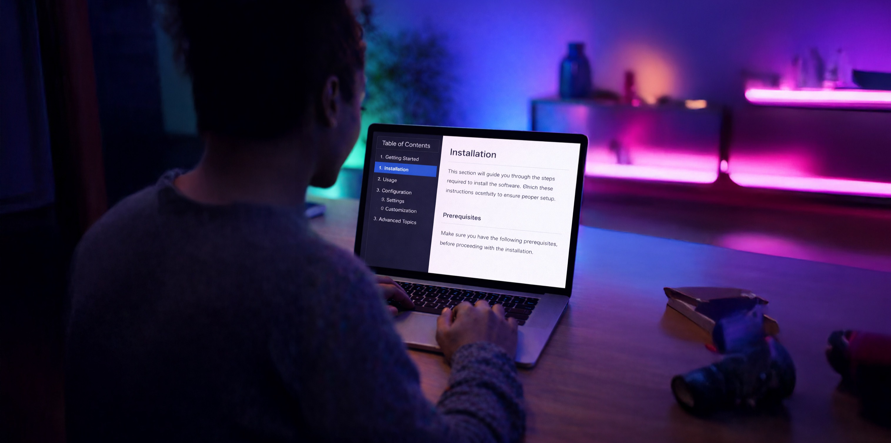 A woman on a laptop with a table of contents showing on the screen