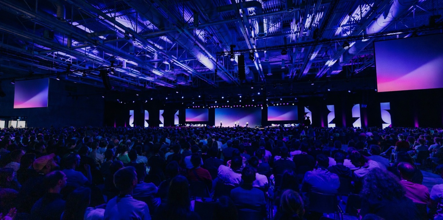 A room full of people at a tech conference