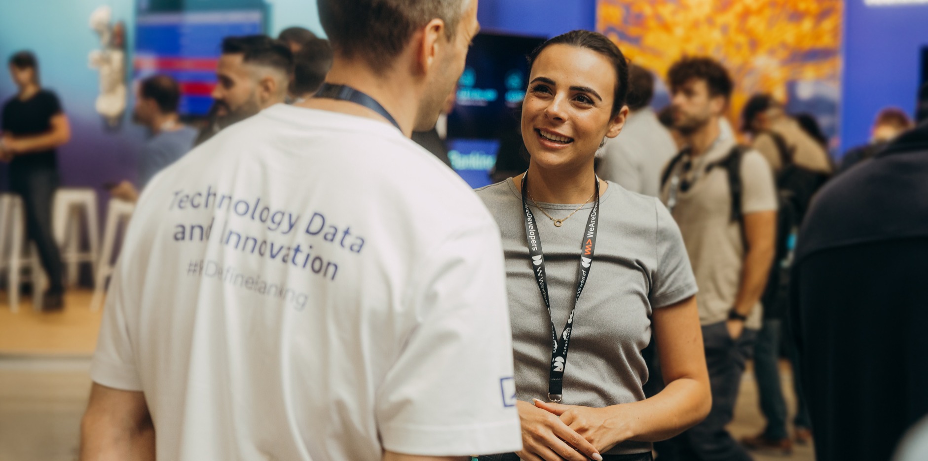 Two people talking at the WeAreDevelopers World Congress, one with their back to the camera