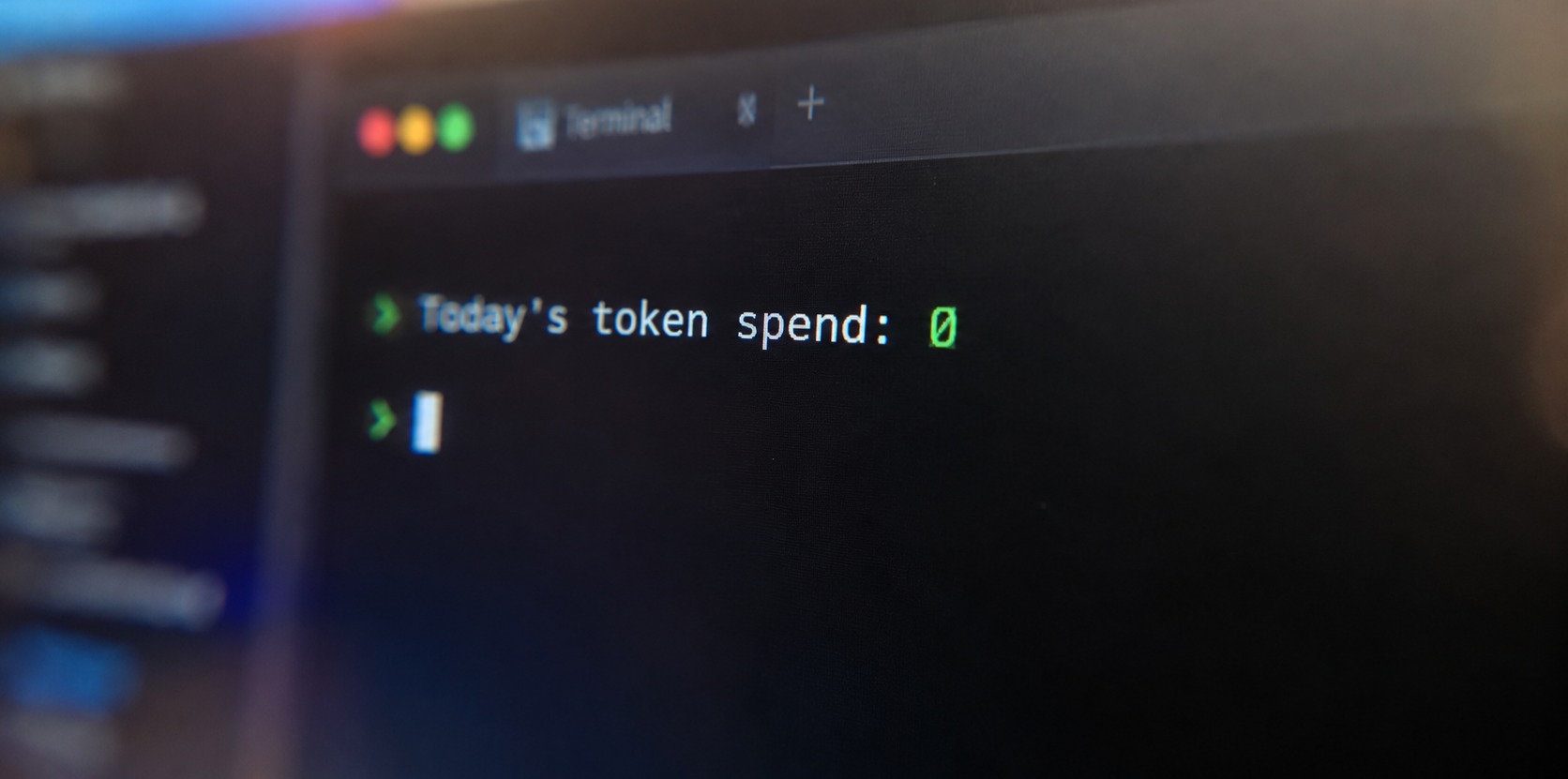 A close-up on a screen showing a terminal with 'today's token spend: 0' on it.